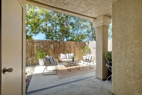 a view of a patio with table and chairs and couches with wooden floor
