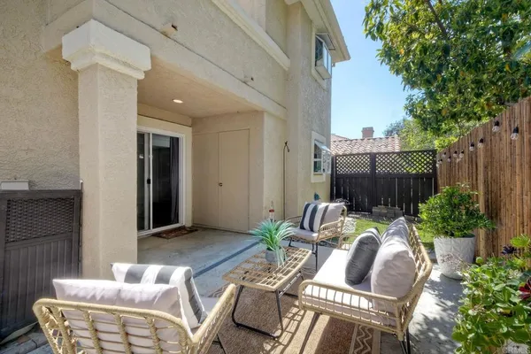 a view of a patio with couches chairs and a potted plant