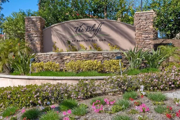 a view of a garden with flowers and trees