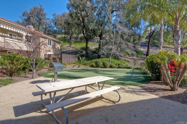 a view of a backyard with a table and chairs