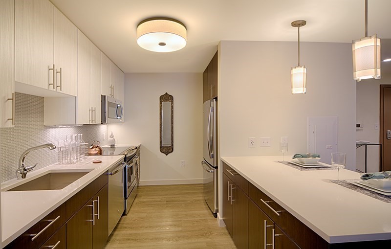 1 Canal Street, Unit 602 Boston, MA 02114 - Photo 2 of 12 a kitchen with a sink stove and refrigerator