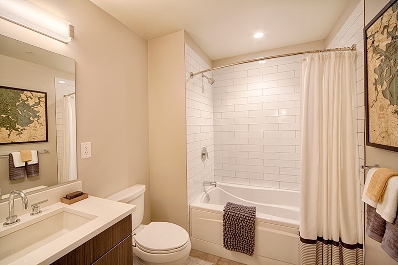 1 Canal Street, Unit 602 Boston, MA 02114 - Photo 5 of 12 a bathroom with a sink a toilet a mirror a vanity and shower