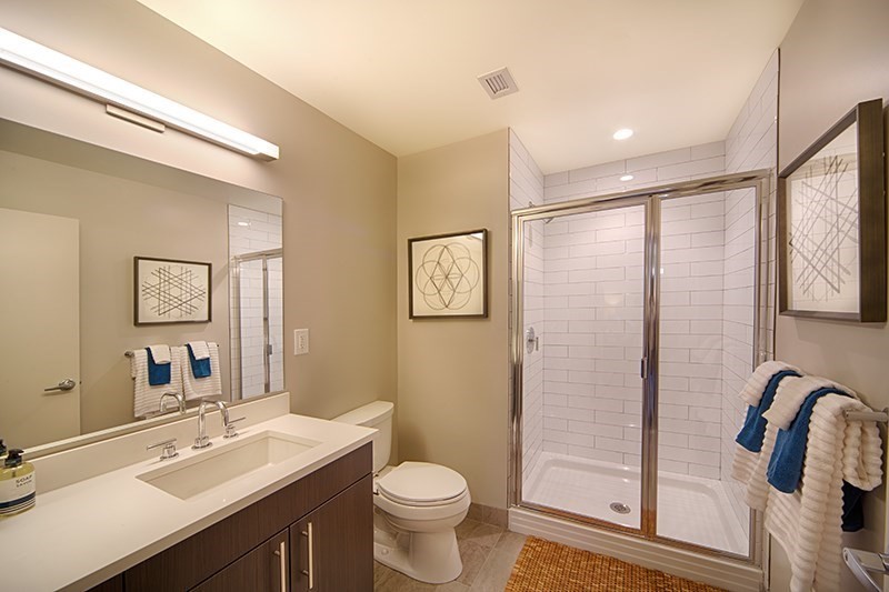 1 Canal Street, Unit 602 Boston, MA 02114 - Photo 7 of 12 a bathroom with a sink a toilet a mirror and shower