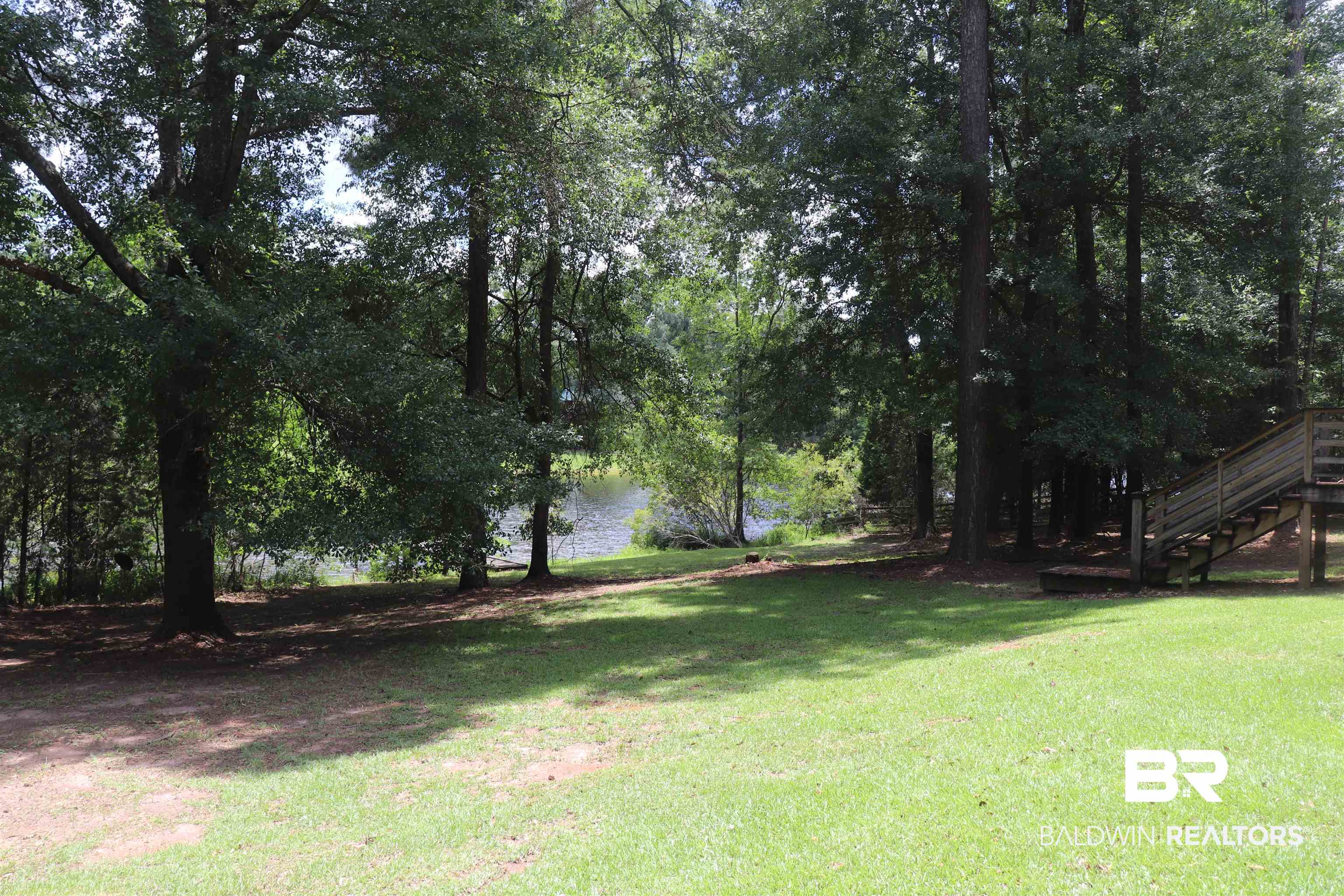 102 Brown Road Evergreen, AL 36401 - Photo 23 of 26 View of green lawn with stairs and a water view