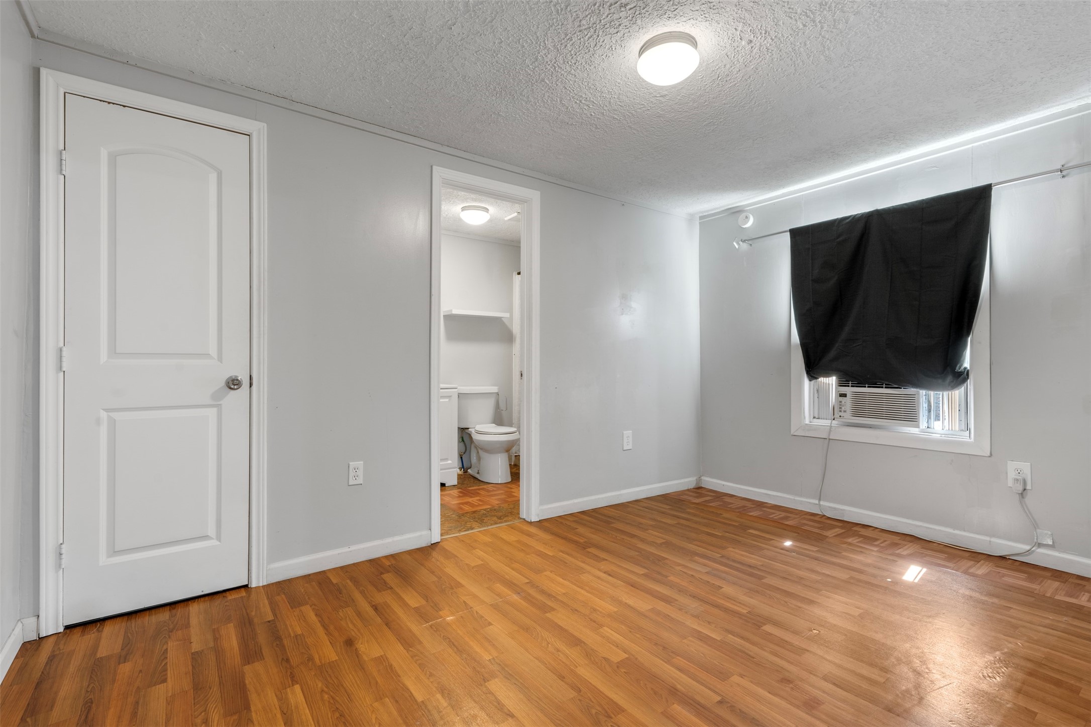 758 Blueberry Road Cove, TX 77523 - Photo 4 of 9 an empty room with wooden floor and windows