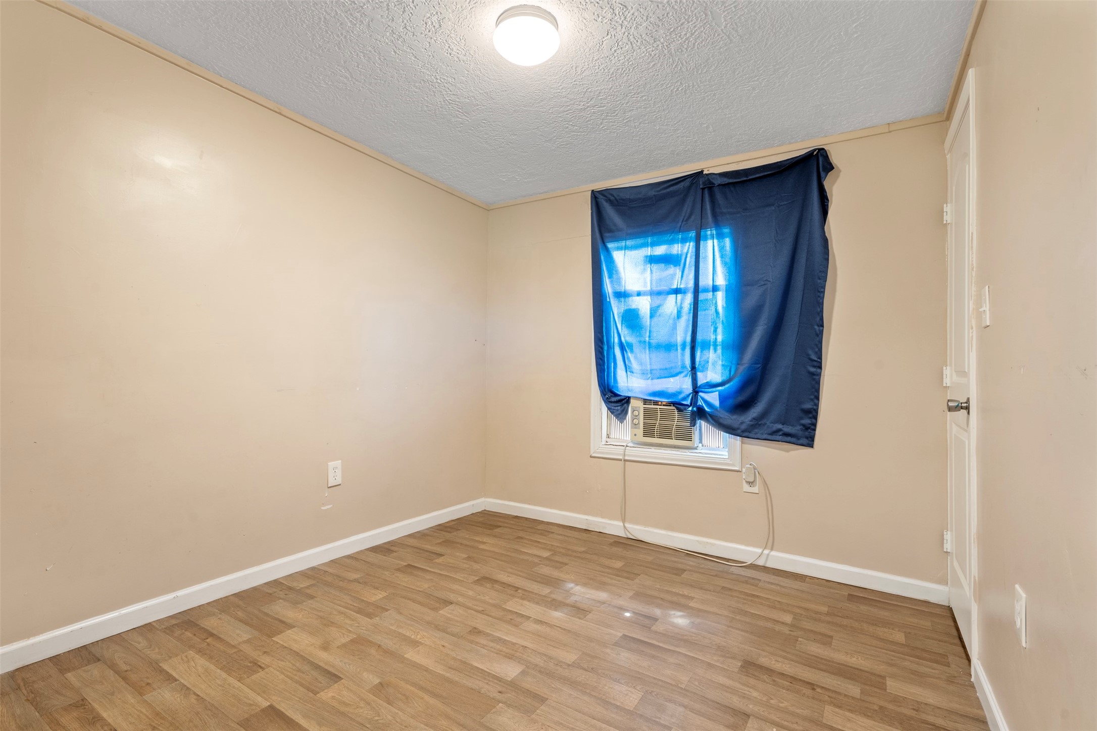 758 Blueberry Road Cove, TX 77523 - Photo 6 of 9 an empty room with wooden floor and windows