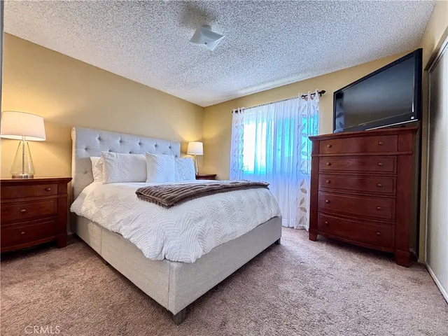 a bedroom with a bed and a dresser