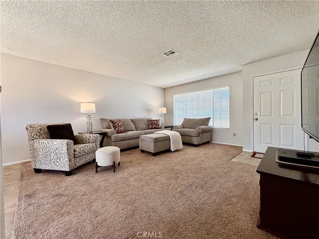 a living room with furniture and white walls