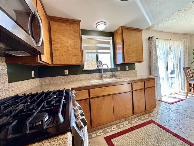 a bathroom with a sink a mirror and a bathtub next to a window