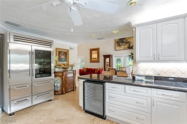 a kitchen with refrigerator and cabinets