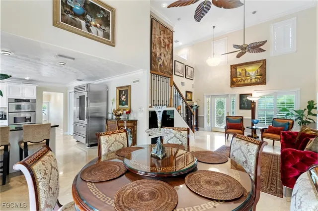 a living room with furniture and floor to ceiling windows
