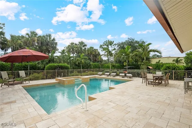 a view of a patio with swimming pool table and chairs