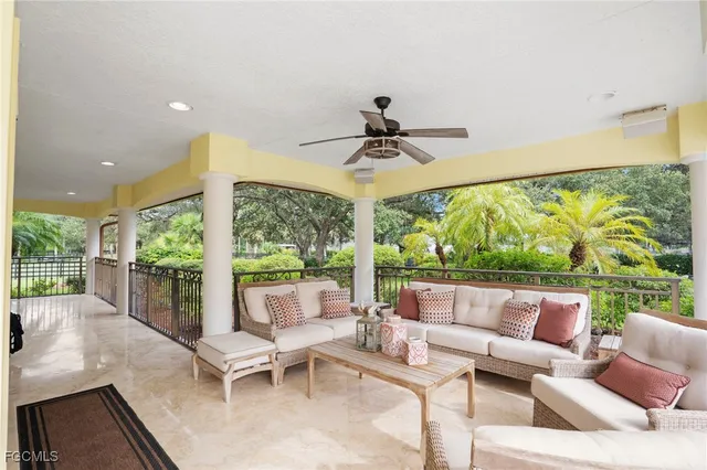 a view of a patio with table and chairs under an umbrella