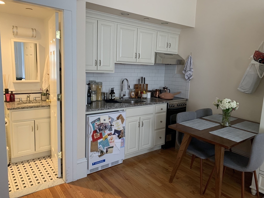 a view of a kitchen with workspace and wooden floor