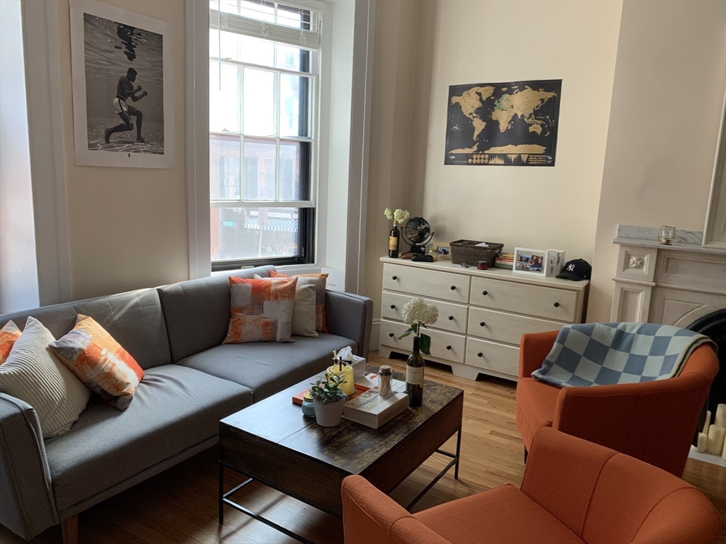 105 Pinckney Street, Unit 2 Boston, MA 02114 - Photo 5 of 13 a living room with furniture and a window