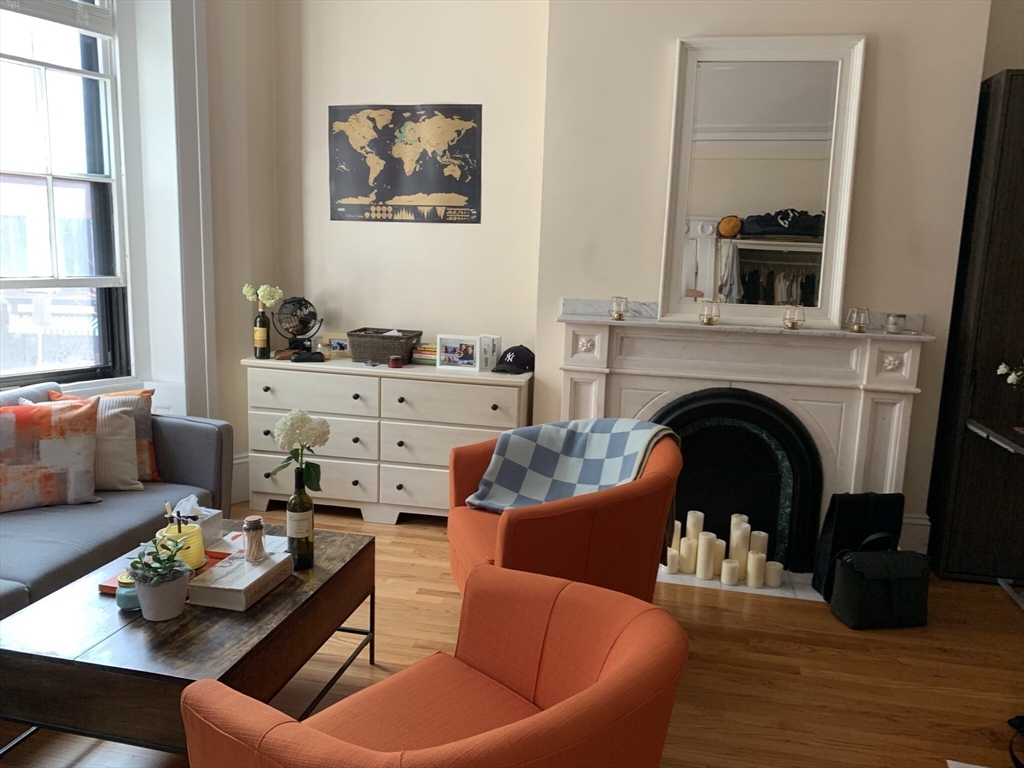 105 Pinckney Street, Unit 2 Boston, MA 02114 - Photo 6 of 13 a living room with furniture and a fireplace