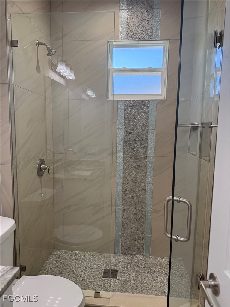 3013 4th Street West Lehigh Acres, FL 33971 - Photo 14 of 47 a bathroom with a toilet and a shower