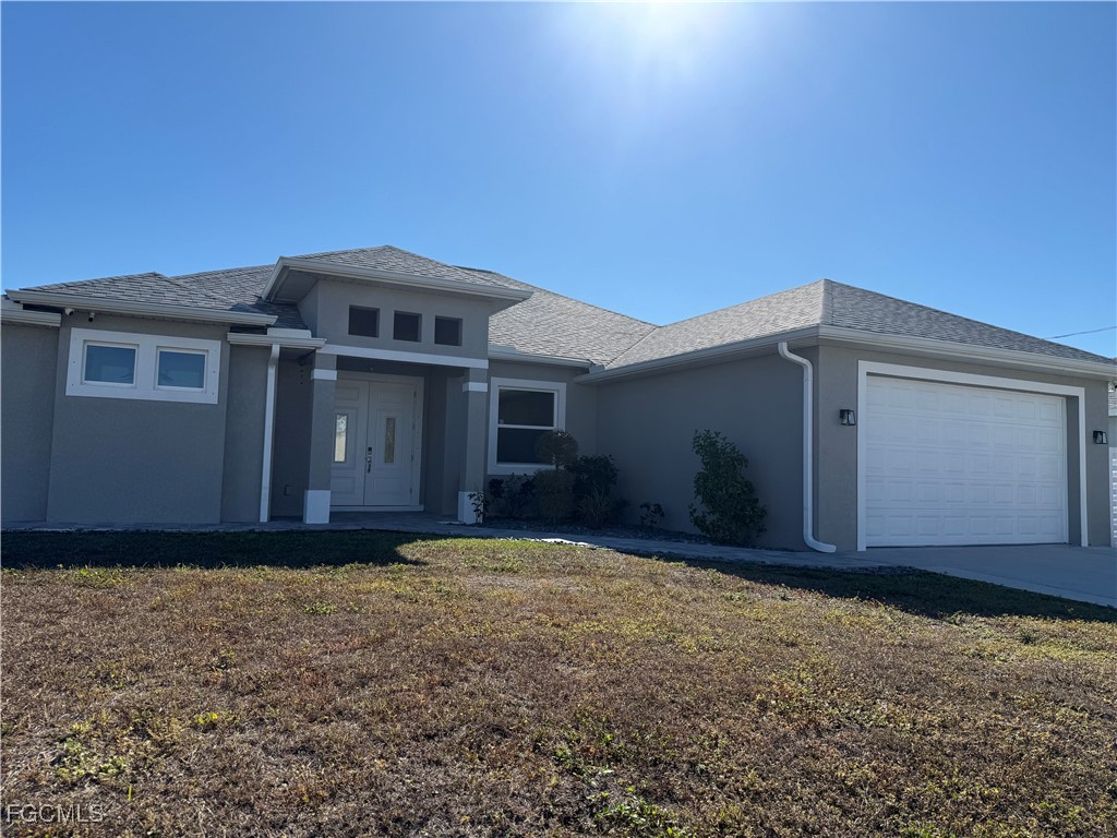 3013 4th Street West Lehigh Acres, FL 33971 - Photo 2 of 47 a front view of a house with a yard