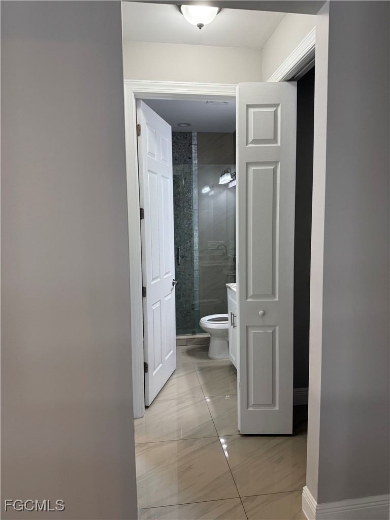 3013 4th Street West Lehigh Acres, FL 33971 - Photo 23 of 47 a spacious bathroom with a toilet