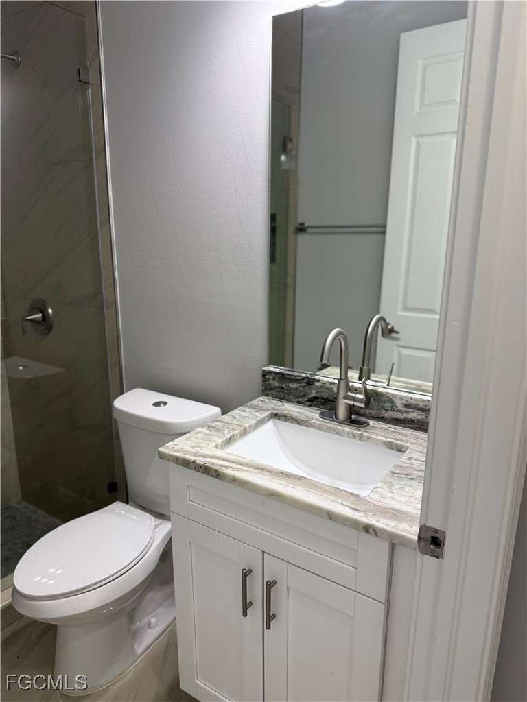 3013 4th Street West Lehigh Acres, FL 33971 - Photo 24 of 47 a bathroom with a sink and a toilet