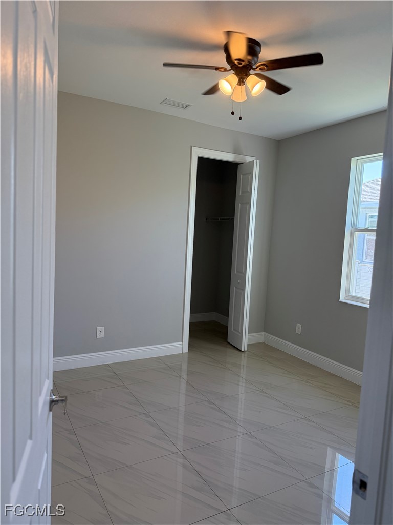 3013 4th Street West Lehigh Acres, FL 33971 - Photo 26 of 47 a view of an empty room with a ceiling fan