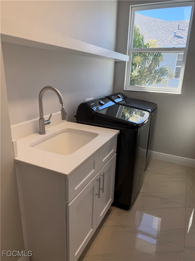 3013 4th Street West Lehigh Acres, FL 33971 - Photo 28 of 47 a kitchen with a sink cabinets and a stove