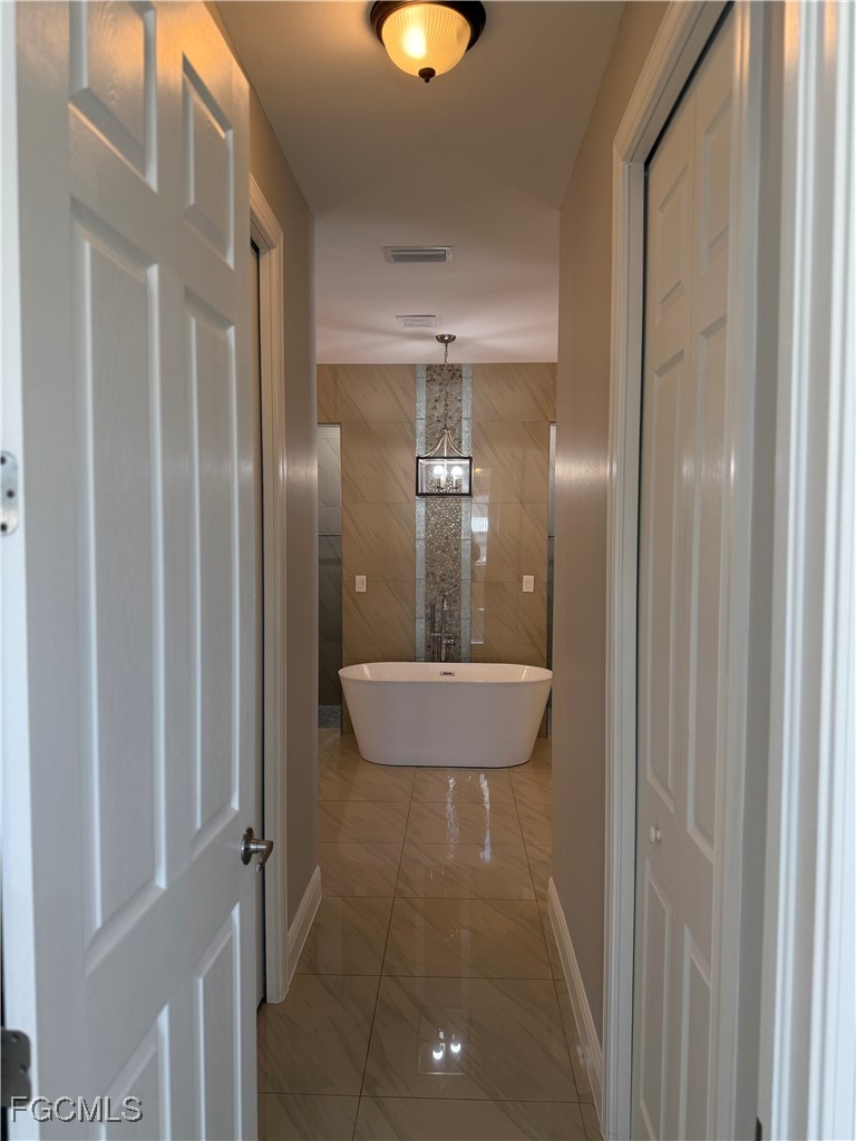 3013 4th Street West Lehigh Acres, FL 33971 - Photo 31 of 47 a bathroom with a mirror and a shower