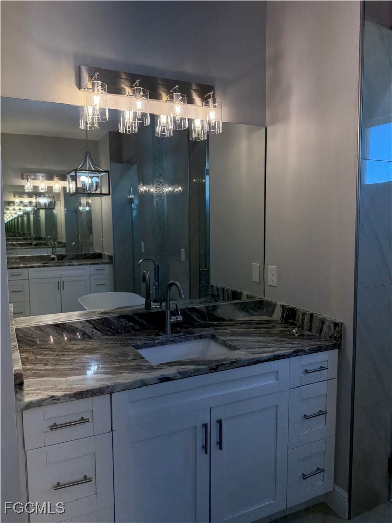 3013 4th Street West Lehigh Acres, FL 33971 - Photo 37 of 47 a bathroom with a sink and a mirror