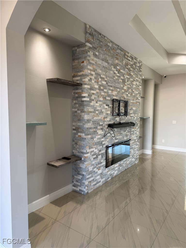 3013 4th Street West Lehigh Acres, FL 33971 - Photo 5 of 47 a kitchen with granite countertop a stove and a refrigerator