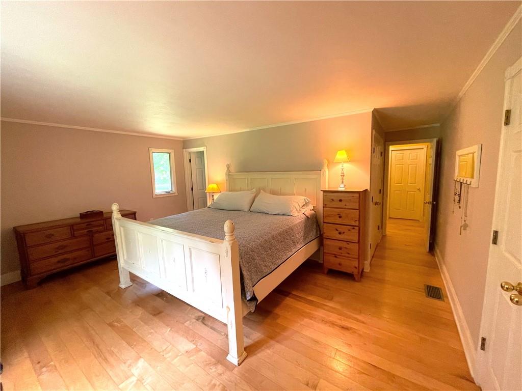 740 Four Mile Run Road Ligonier, PA 15658 - Photo 11 of 12 a bedroom with a bed and a cabinets