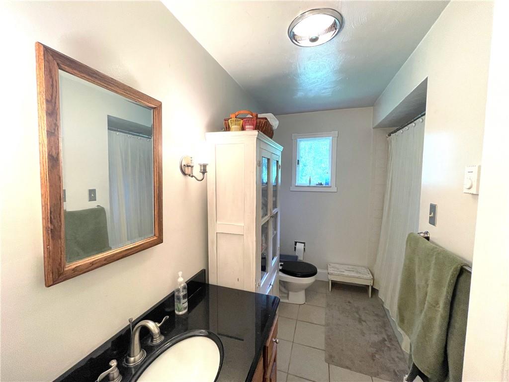 740 Four Mile Run Road Ligonier, PA 15658 - Photo 12 of 12 a bathroom with a sink mirror vanity and toilet