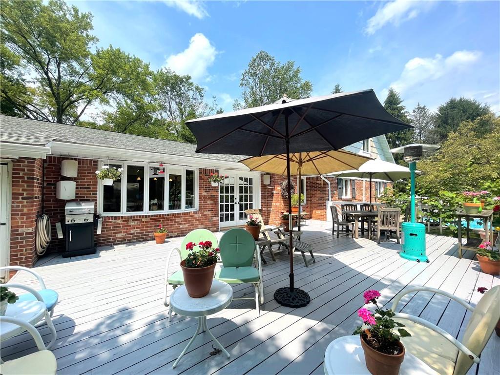 740 Four Mile Run Road Ligonier, PA 15658 - Photo 3 of 12 a view of a patio with table and chairs potted plants with wooden floor