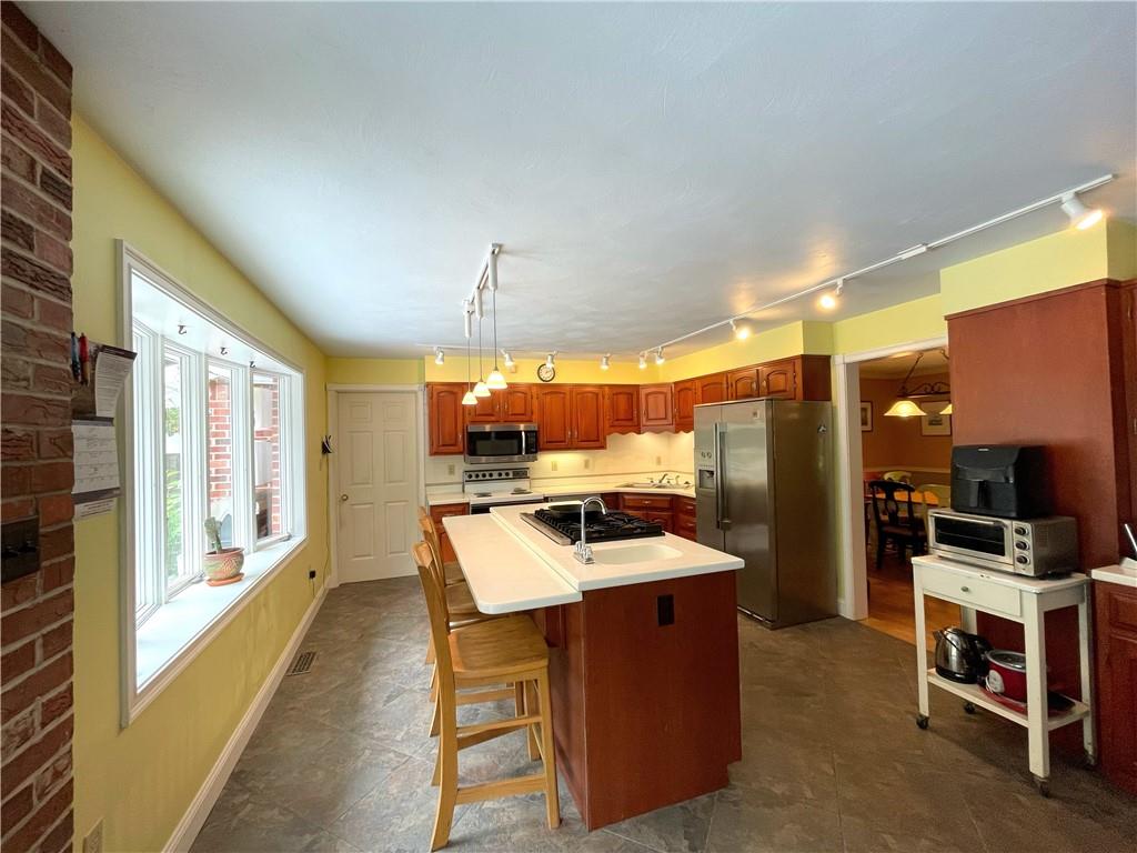 740 Four Mile Run Road Ligonier, PA 15658 - Photo 6 of 12 a dining room with a table chairs and a kitchen view