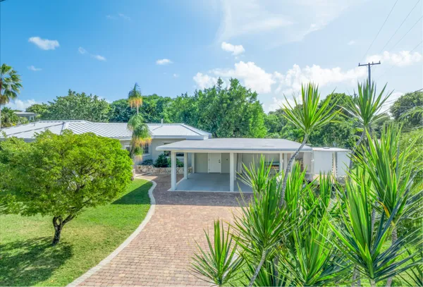 a view of a house with backyard and sitting area