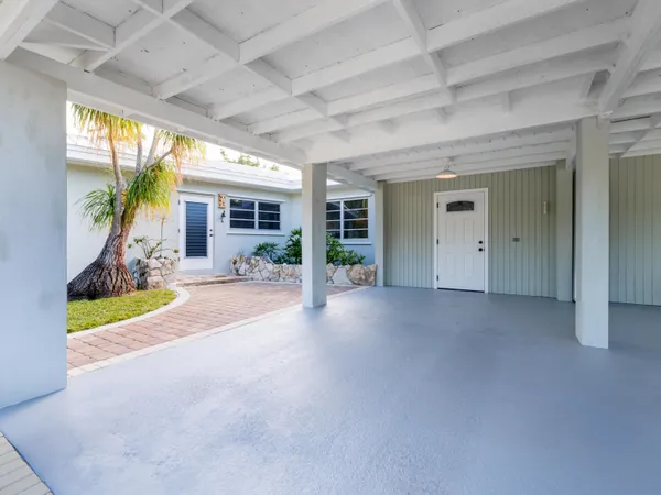 a dining room with furniture and a large window