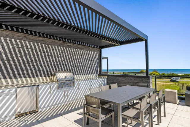 a roof deck with a table and chairs