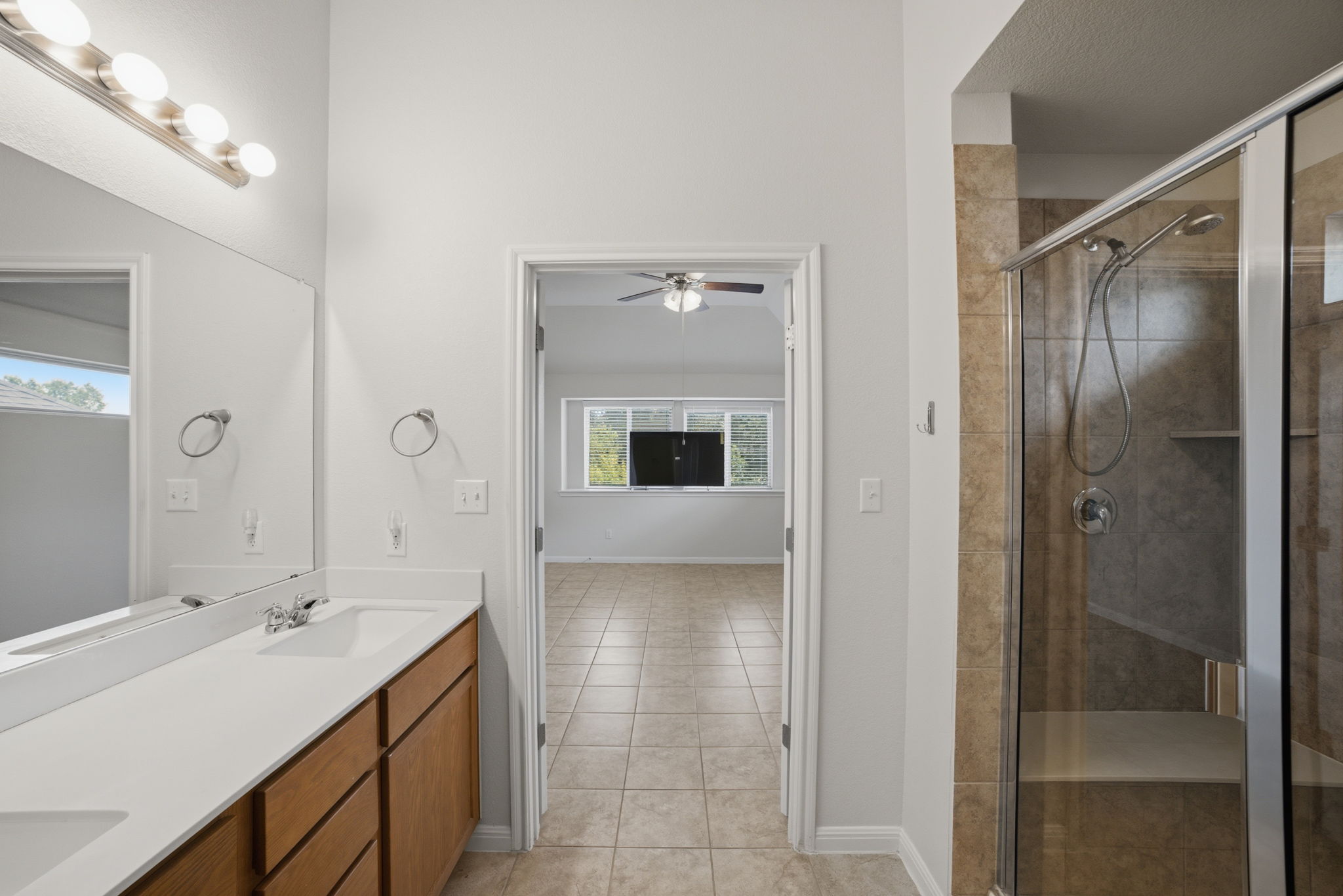 514 Nautical Loop Kyle, TX 78640 - Photo 15 of 24 A well-appointed primary bathroom featuring a spacious double vanity and a glass-enclosed shower.