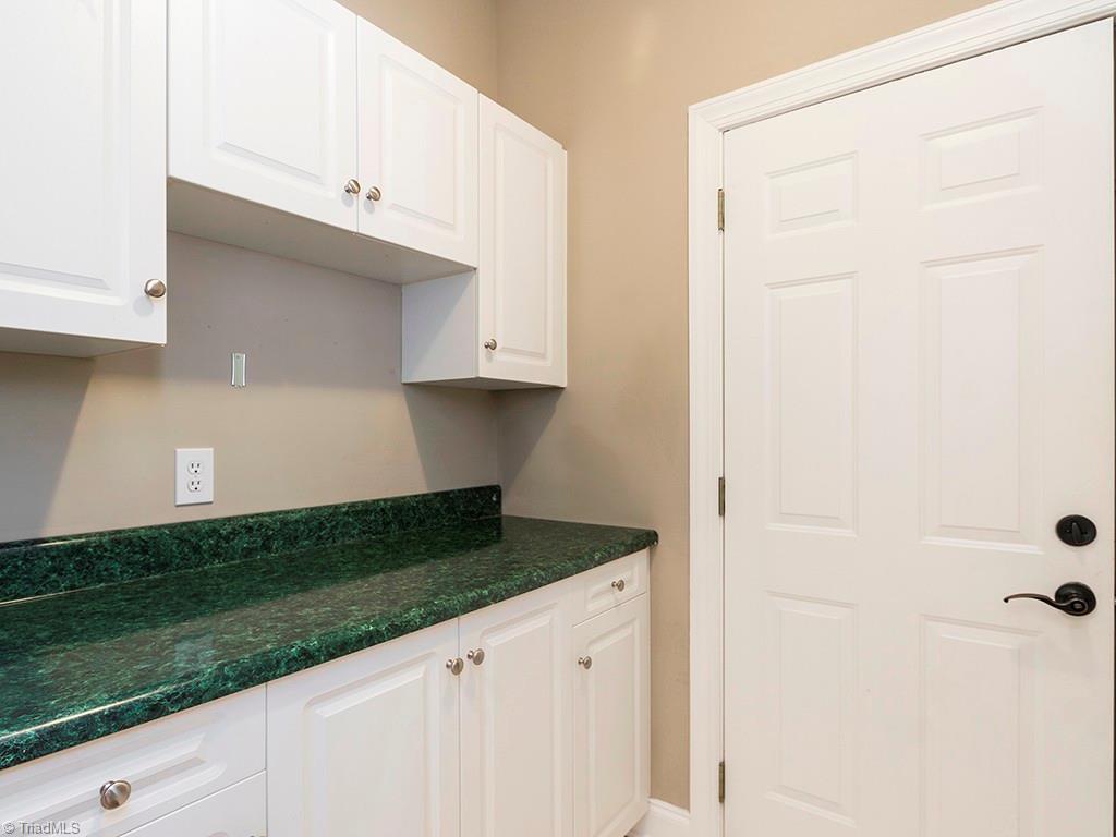 8302 Case Ridge Drive Oak Ridge, NC 27310 - Photo 8 of 29 Large laundry with storage and folding area. Access to garage.