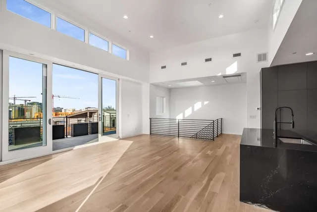 a view of kitchen with kitchen island microwave and stove top oven
