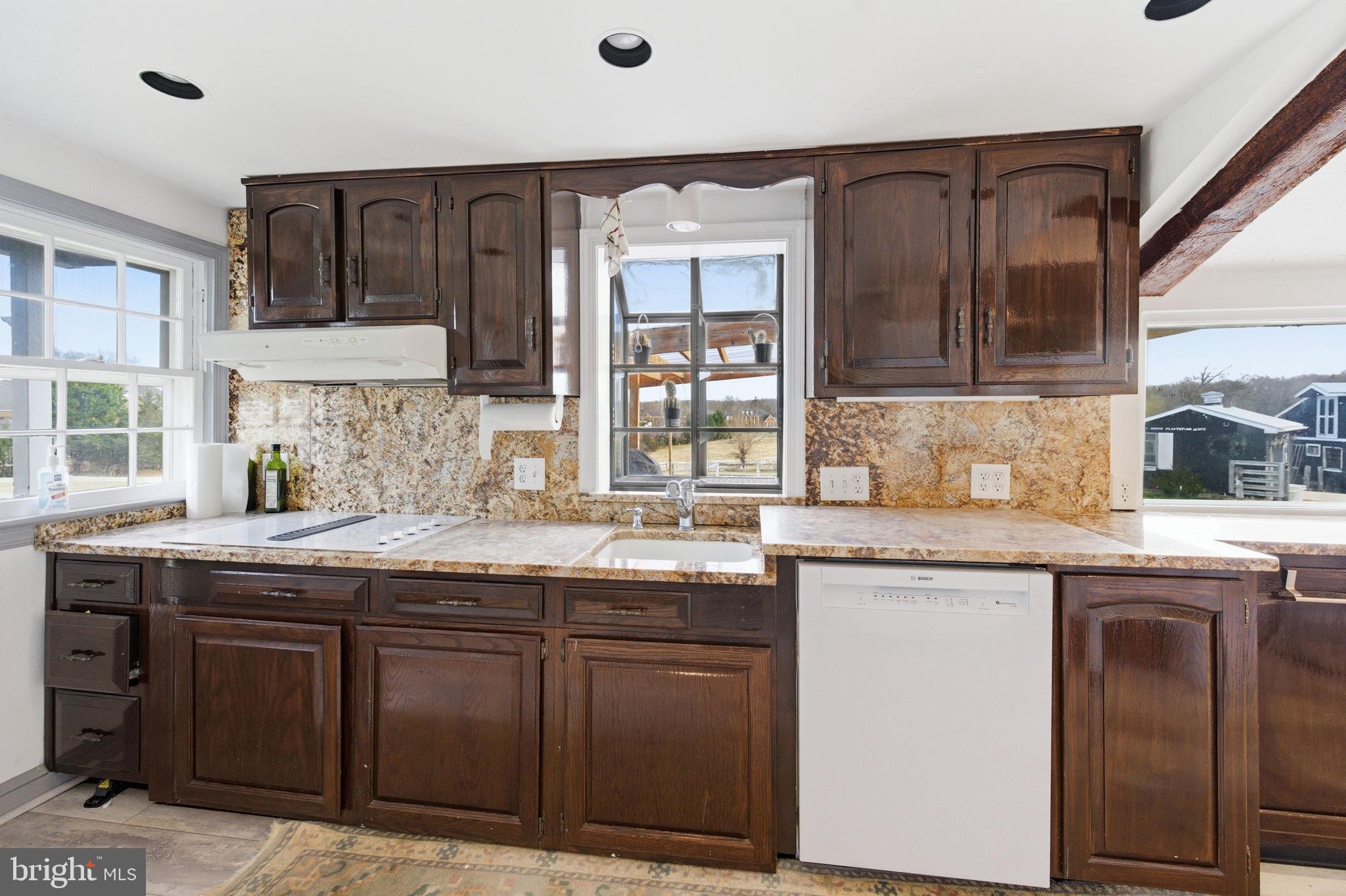 11641 Glen Road Potomac, MD 20854 - Photo 11 of 40 a kitchen with granite countertop cabinets sink and window