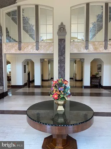 a vase with flowers in front of it