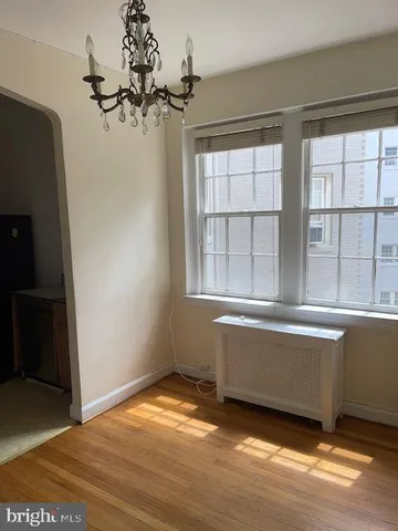 a view of a room with wooden floor and a window