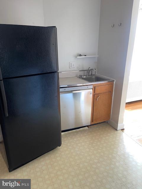 2737 Devonshire Place Northwest, Unit 327 Washington, DC 20008 - Photo 7 of 16 a view of a refrigerator in kitchen and an empty room