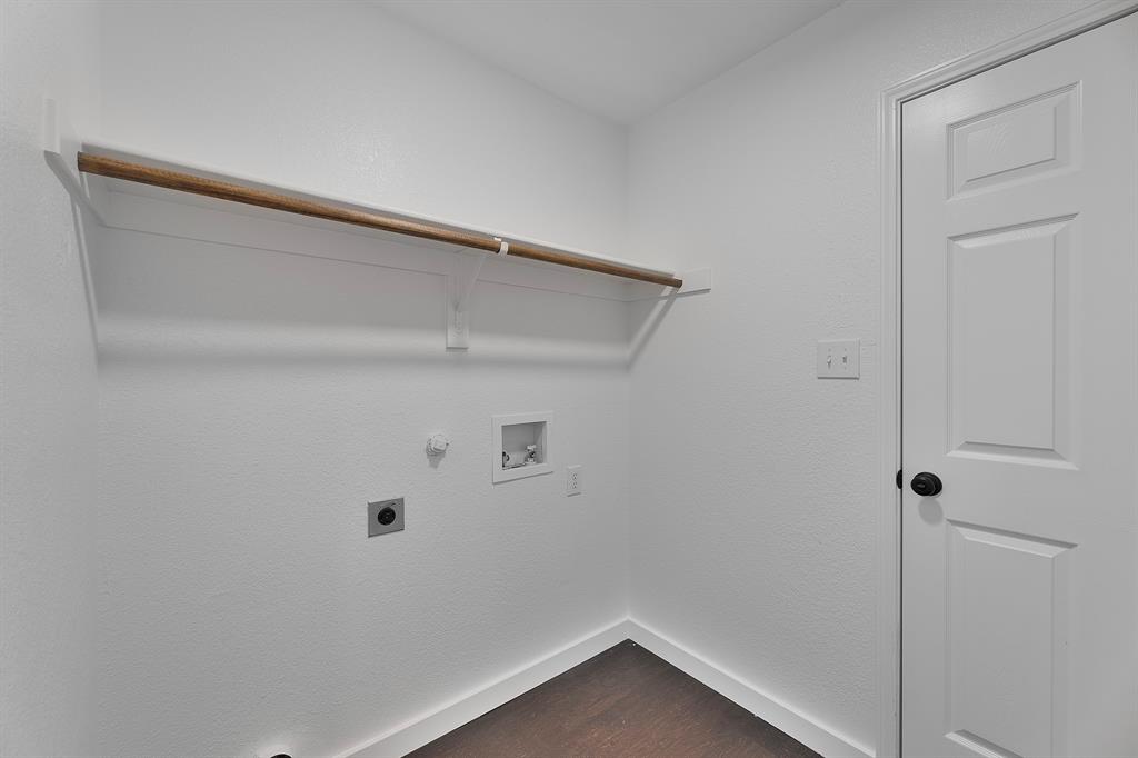 605 Clearbrook Street Azle, TX 76020 - Photo 23 of 33 Dedicated utility space featuring a wood-finish hanging rod, white shelving, and dark wood-finish flooring