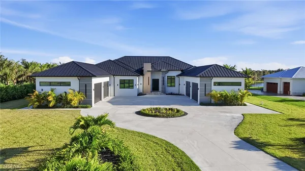 a large white bathroom with a large tub sink and vanity