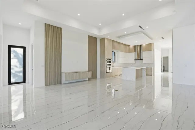 a view of a big room with wooden cabinet and windows