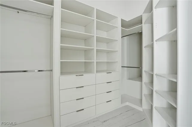 a view of walk in closet with empty racks