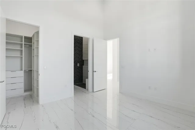 an empty room with closet and mirror