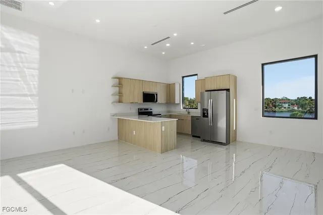 a large white kitchen with a large window