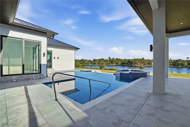 a view of swimming pool with outdoor seating and a yard